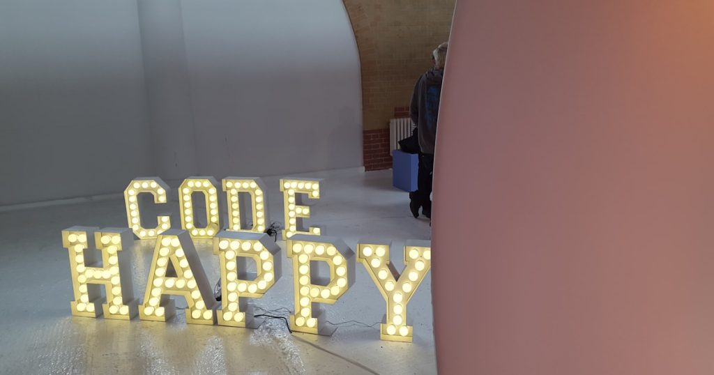 two sets of brown Code Happy marquee lights